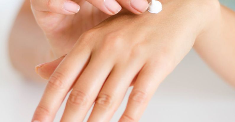 Nail Care - Woman Applying Lotion on Hand
