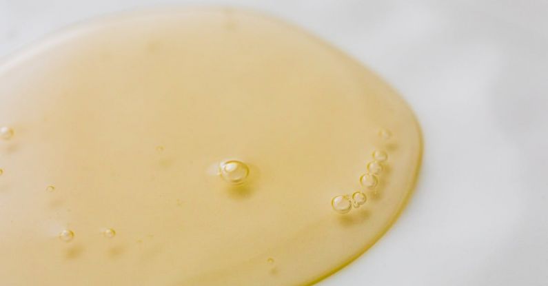 Shampoos - Transparent yellowish liquid on white surface