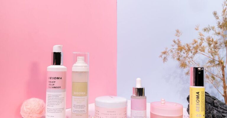 Moisturizers - Pink and White Bottles on Pink Surface
