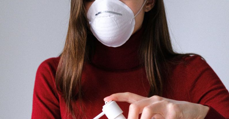 Masks - Woman Applying Hand Sanitizer